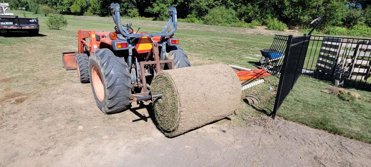 Roll of sod on a tractor during a lawn install