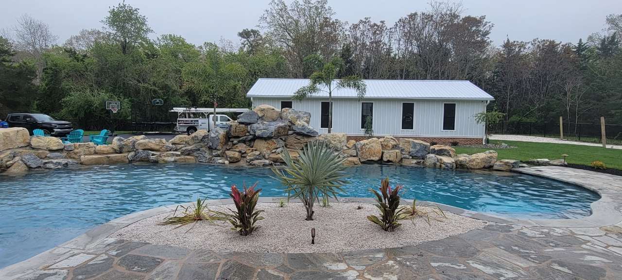 Natural rock pool with stone coping and poolside plantings