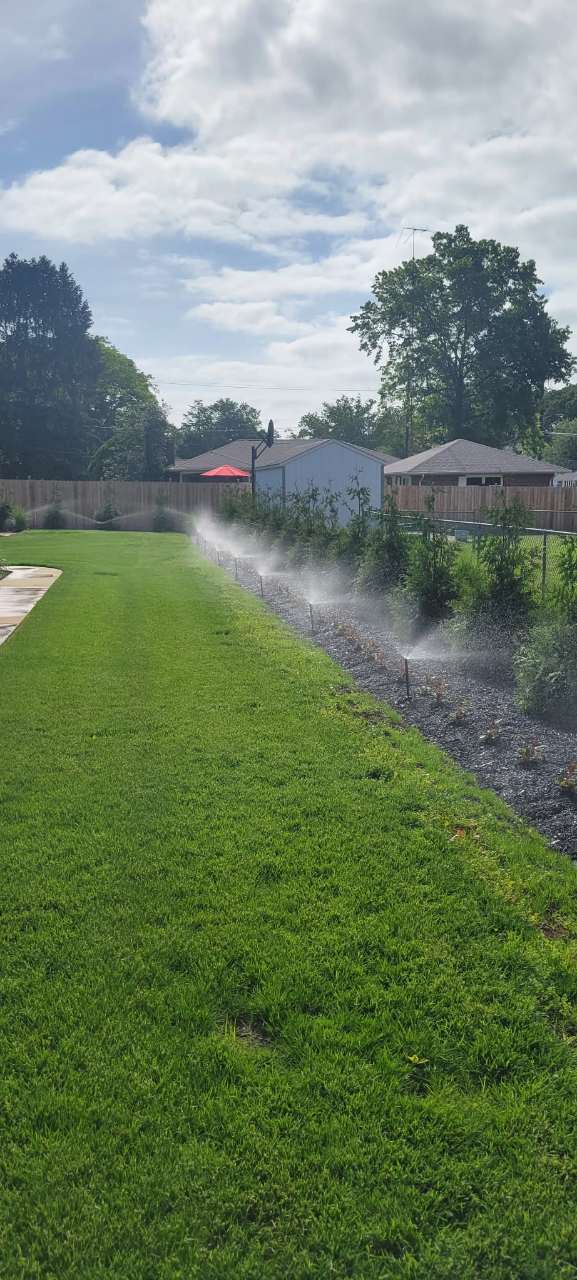 Wetlawn sprinkler system running across a striped lawn