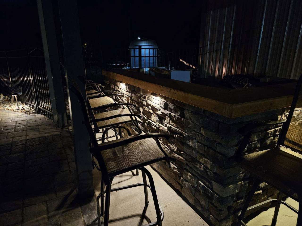 Outdoor bar and stone column lit at night