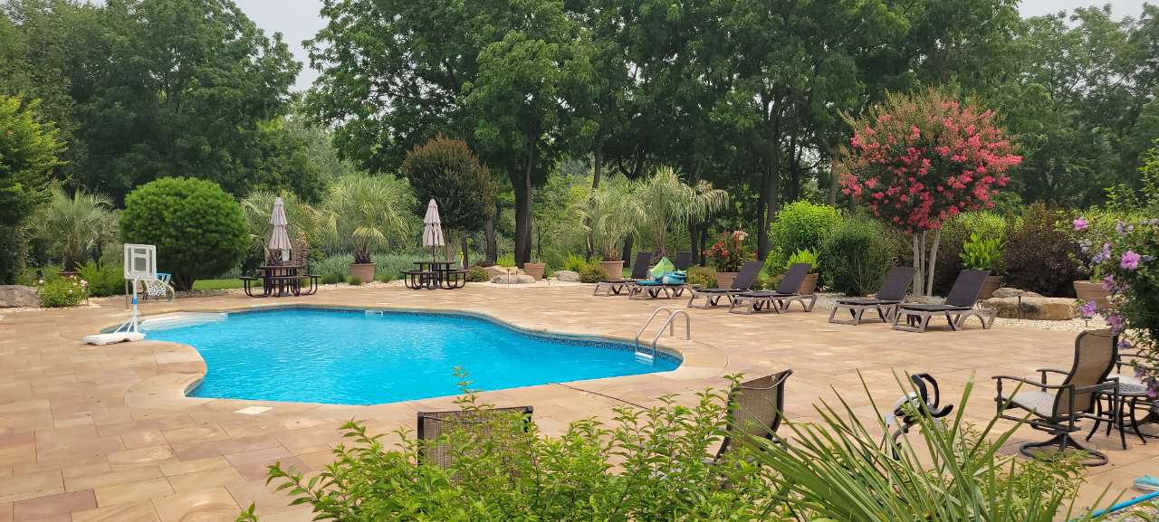 Pool, patio and planted borders at a finished property