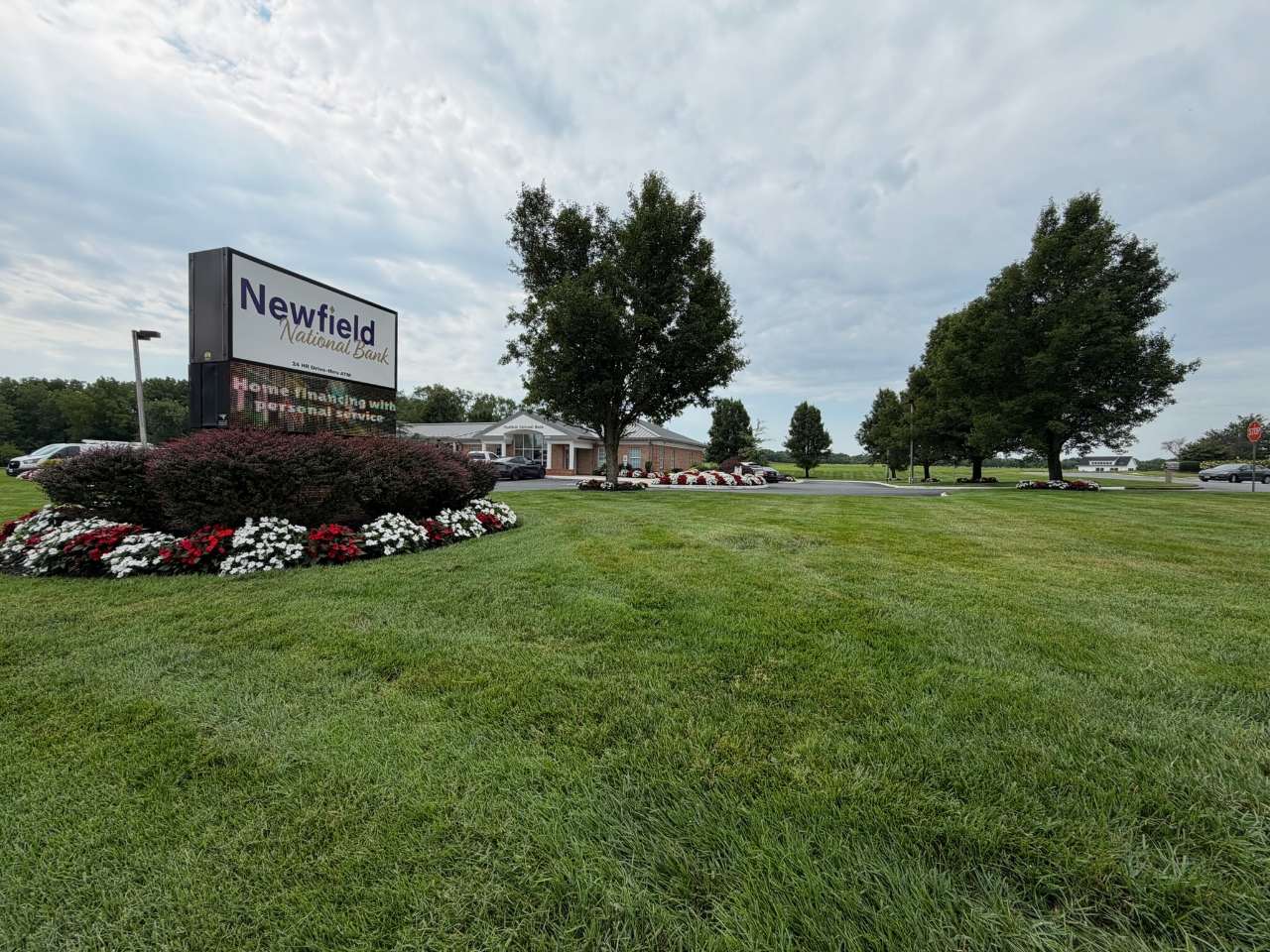 Flower island and grounds at Newfield National Bank