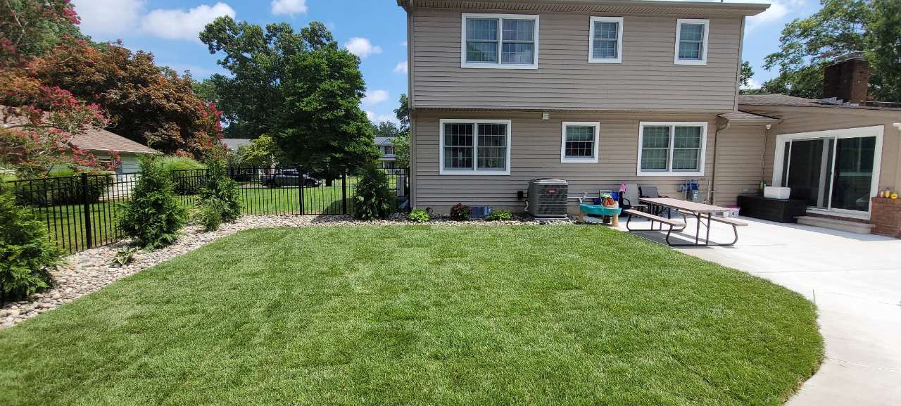 Wide sod lawn behind a two-story home