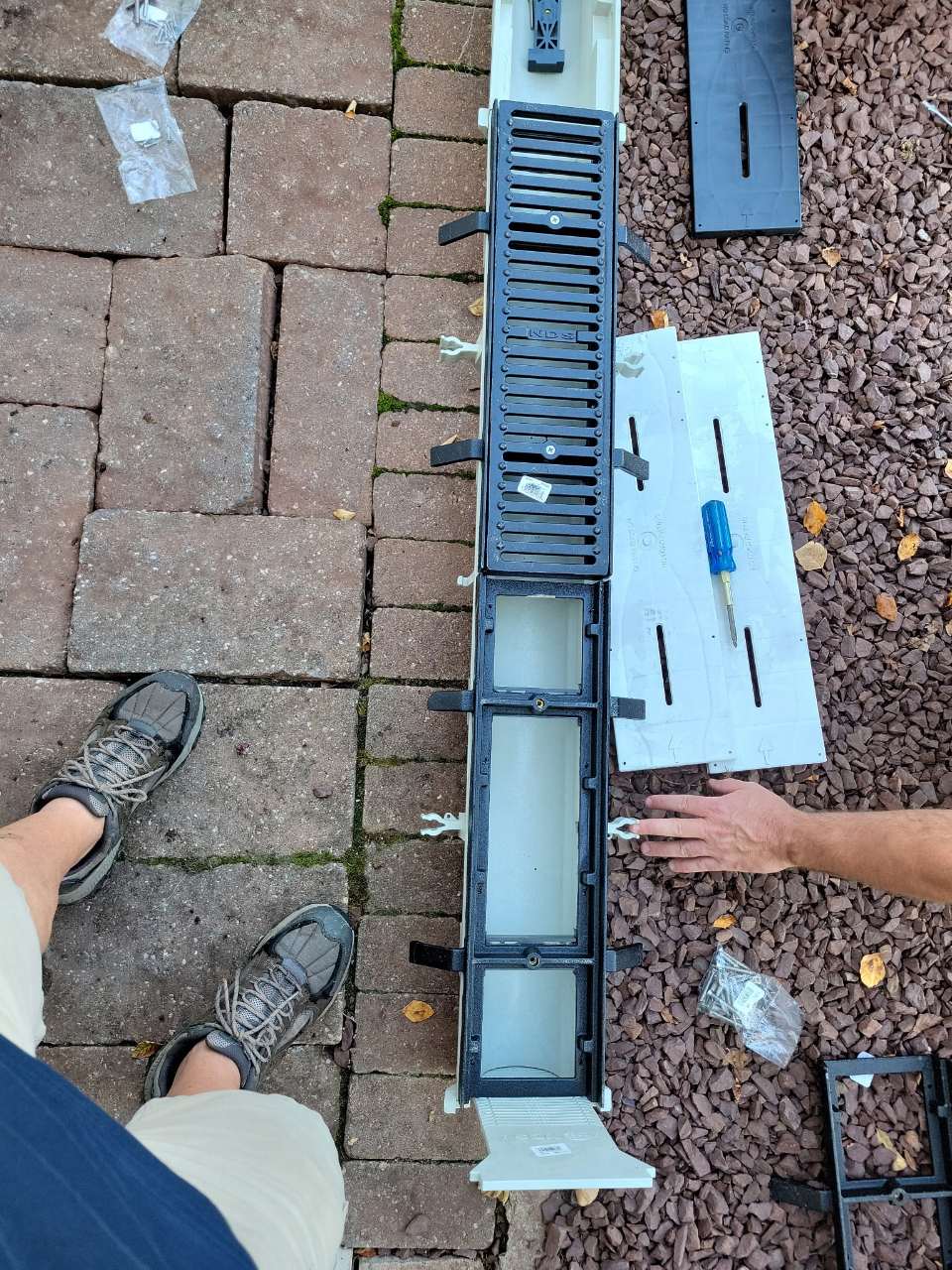 Channel drain being set into a paver walkway
