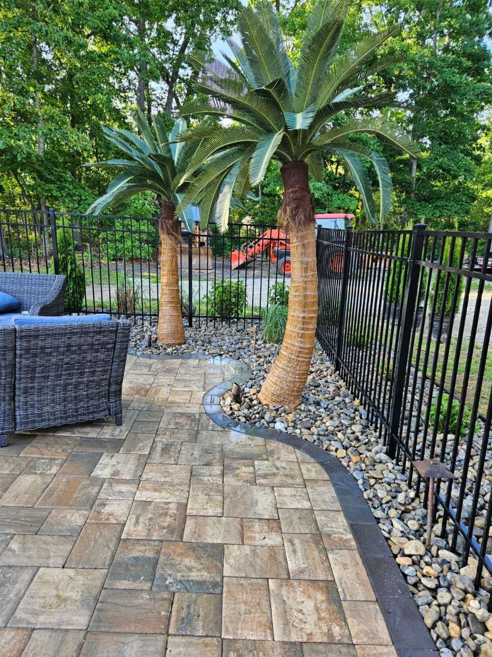 Paver walkway with palm and river-rock border
